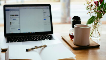 Notepad and laptop on desk
